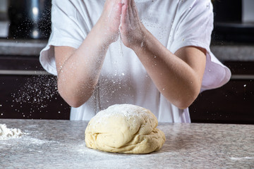 Fototapeta premium Girl making pizza dough