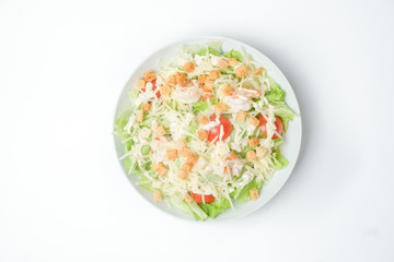 light summer salad in a white plate on a white background