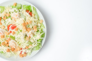 light summer salad in a white plate on a white background
