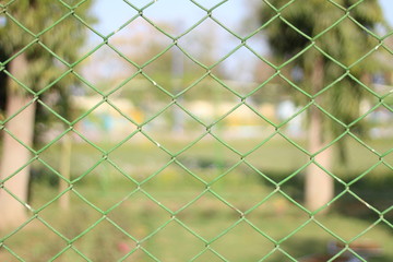 Fototapeta premium wire fence with green grass