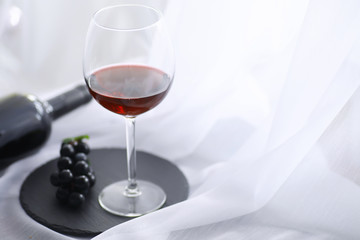 Glass with grape red semi-dry wine. Valentine's day concept background. Gift for the holiday. Sweet sparkling wine.