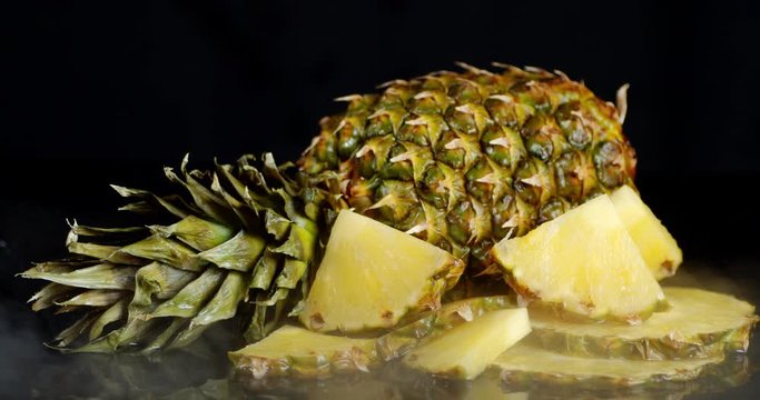 Sliced and whole pineapple with cool steam.