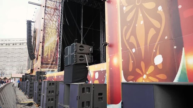 Big concert speakers and line arrays prepared for the festival. Close up of subwoofers and stage outdoor sound system.