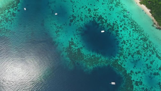 Aerial top view of beauty nature landscape with beach, corals and sea on tropical Koh Rok island, Thailand, 4k