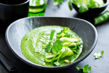 Green cold spinach and cucumber soup. Selective focus.