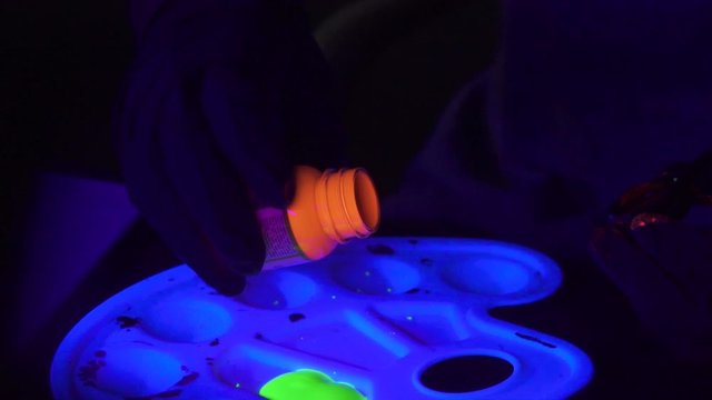 Pouring Neon Glow in the Dark Acrylic Paint from bottle to Painter's Palette in Slow Motion