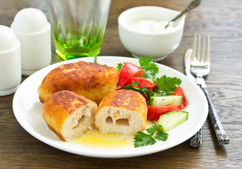 Chicken Kiev with vegetable salad. Ukrainian food.
