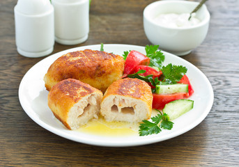 Chicken Kiev with vegetable salad. Ukrainian food.