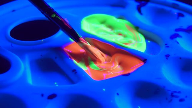 Close Up of Paint brush and Neon Glow in the Dark Acrylic Paint