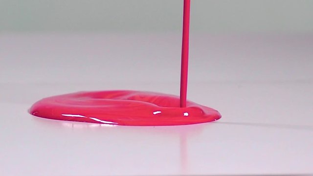 Red/Pink Acrylic Paint Pouring, Spilling, dripping onto White Background. Slow Motion 120fps Close Up