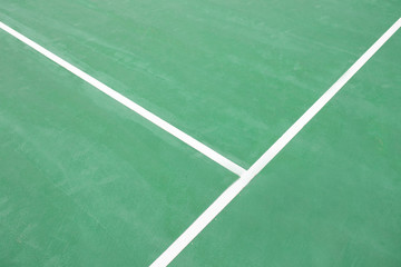 Green tennis court surface.