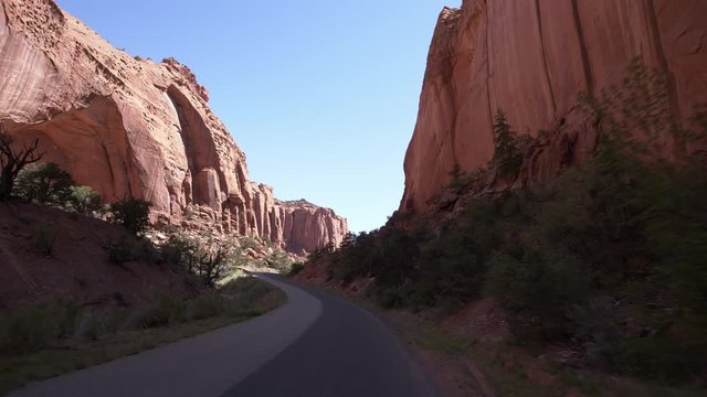 Driving on the Burr Trail as the road cuts through the canyon through Grand Staircase Escalante National Monument in Utah.