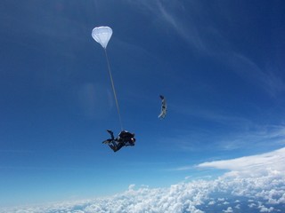 Naklejka na ściany i meble Low Angle View Of Man Paragliding Against Sky