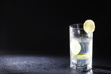 Lime water. Drinking water with fresh lime. Mineral water. Healthy, mineral-rich, refreshing water with lime.
