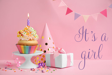 Composition with baby shower cupcake for girl on pink background