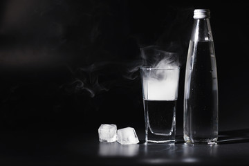 Close up pouring purified fresh drink water from the bottle on table in living room. Drinking water. Mineral vitamin water. Healthy, mineral-rich, refreshing water.