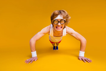 Portrait of his he nice funky motivated mad desperate foxy guy doing work out body building goal squatting endurance isolated over bright vivid shine vibrant yellow color background - obrazy, fototapety, plakaty