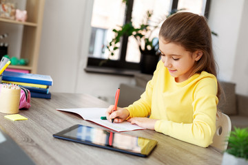 children, education and learning concept - happy student girl with tablet pc computer writing to...