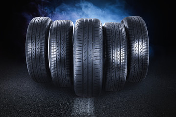 Car tires and smoke on road against black background © New Africa