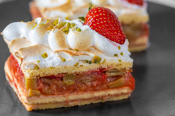 Piece of Strawberry Rhubarb Cake on a black Plate