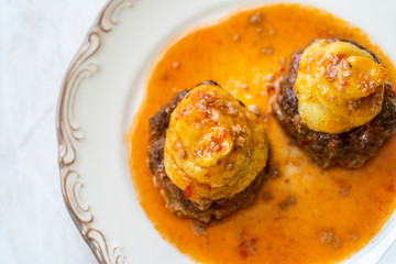 Turkish Food Hasanpasa Kofte / Kofta with Puree / Meatball with Bechamel, Tomato Paste Sauce and Green Peas.