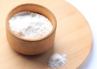 Fototapeta na wymiar white salt in a wooden bowl on a wooden board
