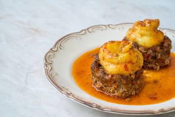 Turkish Food Hasanpasa Kofte / Kofta with Puree / Meatball with Bechamel, Tomato Paste Sauce and Green Peas.