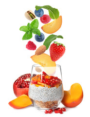 Delicious yogurt with nuts, fruits and berries on white background