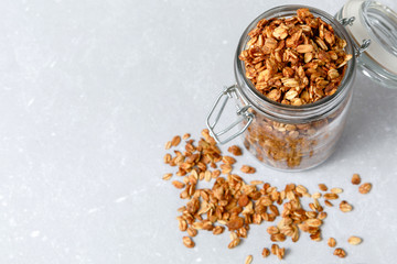 Oatmeal granola cereal in open glass jar