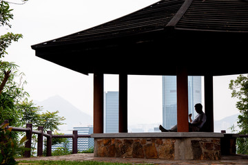 Relaxing man in Hong Kong gazebo structure 