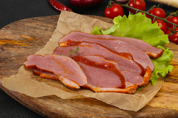 Sliced smoked duck breast served salad