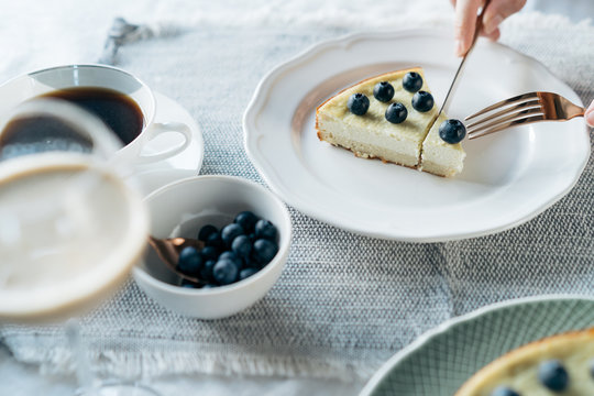 Cup of coffee and cake with blueberries