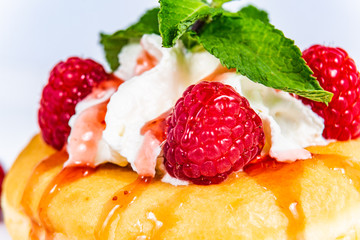 Delicious dessert of donuts. Sweet donuts with different fresh fruit and decorations. Closeup