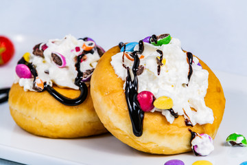 Delicious dessert of donuts. Sweet donuts with different in sweet colored glaze and decorations. Closeup