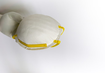 Hands holding protective medical face mask.