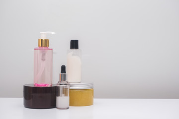 Cosmetic bottles on the white table.
