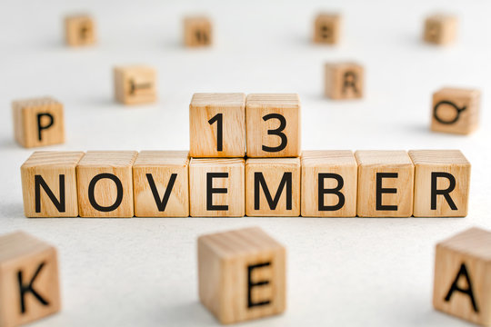 November 13 - from wooden blocks with letters, important date concept, white background random letters around