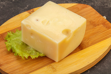 Emmental cheese over wooden board