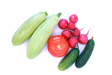 Tomato, cucumbers, radishes and zucchini on a white background, close-up