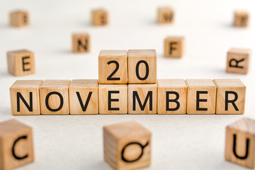 November 20 - from wooden blocks with letters, important date concept, white background random letters around