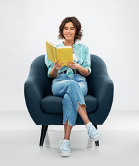 comfort, people and furniture concept - portrait of happy smiling young woman in turquoise shirt...