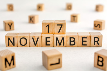November 17 - from wooden blocks with letters, important date concept, white background random letters around