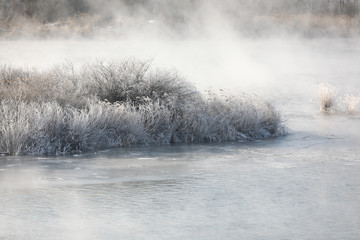 Trees and reeds are covered with snow, and the river has water mist. Soyang River, Chuncheon City, Korea - 346762299