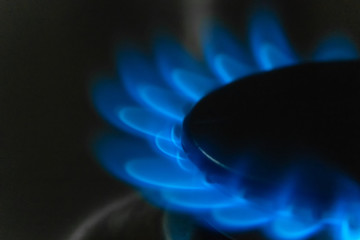 Blue flame of burning gas on a gas stove macro