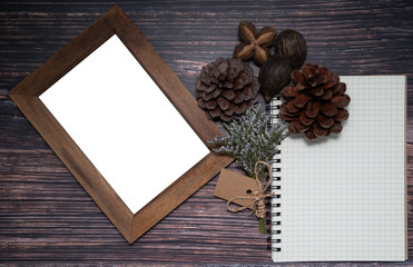 Blank grid-lined notebook and picture frame decorated with small dried flower bouquet with blank brown card and dried pine cone, Sacha Inchi, Foxtales palm