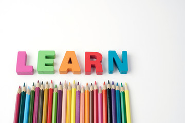  ' LEARN " Colorful Wooden Letters  with Color Pencil on White Background                                                            