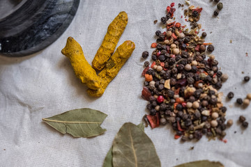 Natural spices pepper and bay leaf, turmeric root
