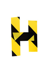 Letter H from yellow black warning tape on white