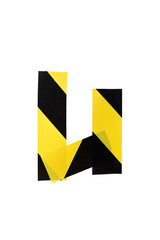 Letter U from yellow black warning tape on white