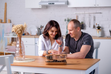 young couple plays in a bright kitchen laughing and joy